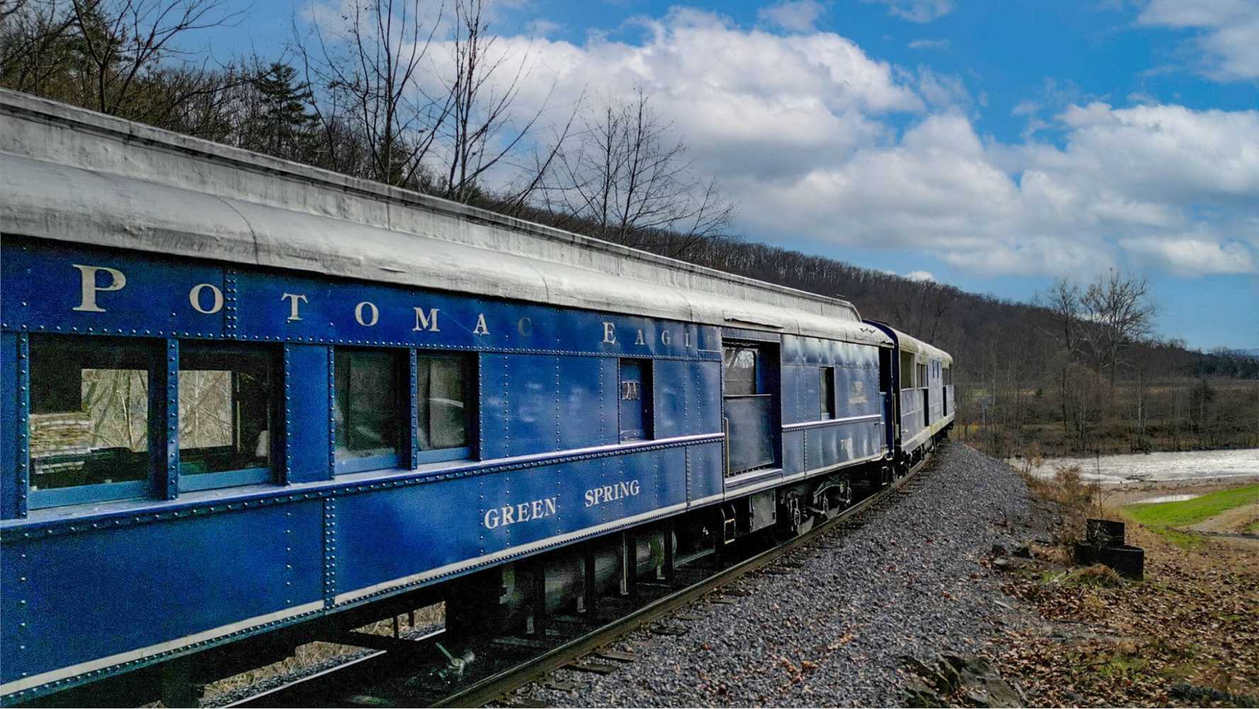 a blue train on a steel track