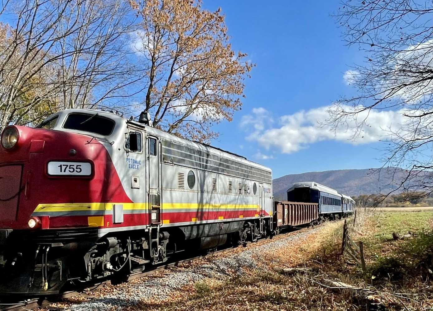 a train on a train track with trees in the background