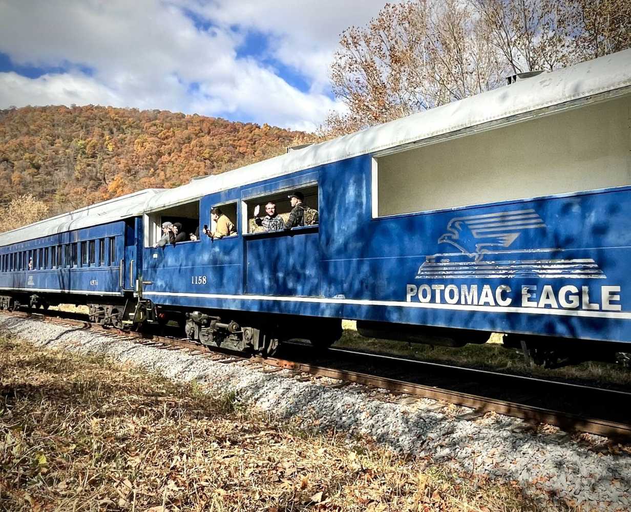 a blue train going down the track