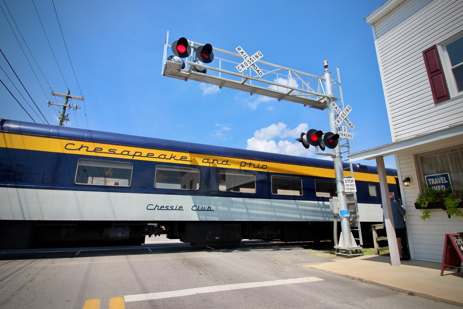 a train is crossing at a railroad crossing