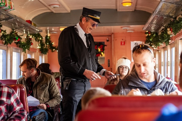 Conductor checking tickets in Standard Coach