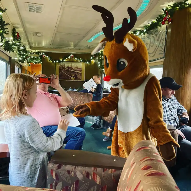 Rudolph greatinga little girl in First Class during the North Pole Express