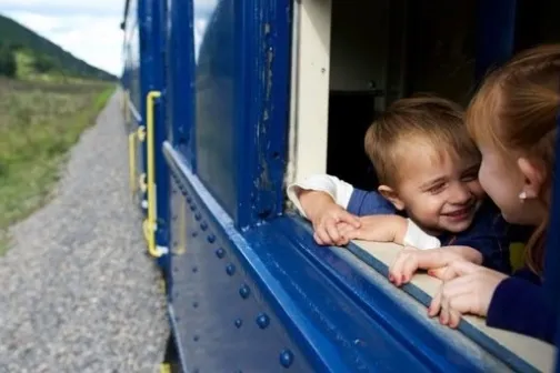 a little boy looking out the open air car window on the Potomac Eagle train