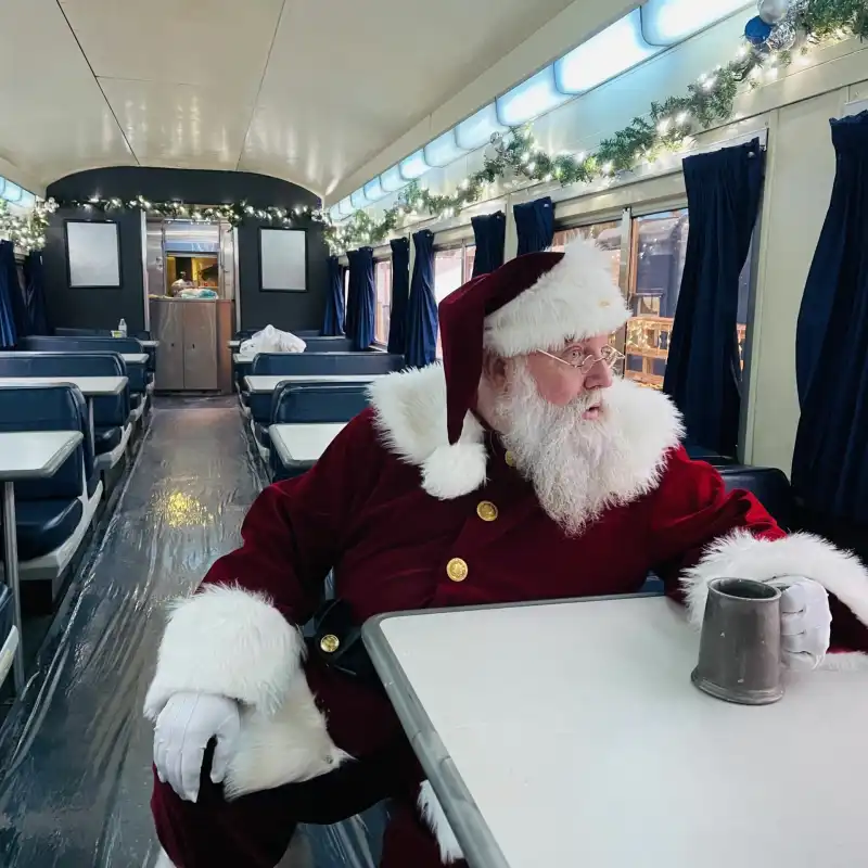 Santa Clause sitting in Premium Dining with his goblet of Hot Coco