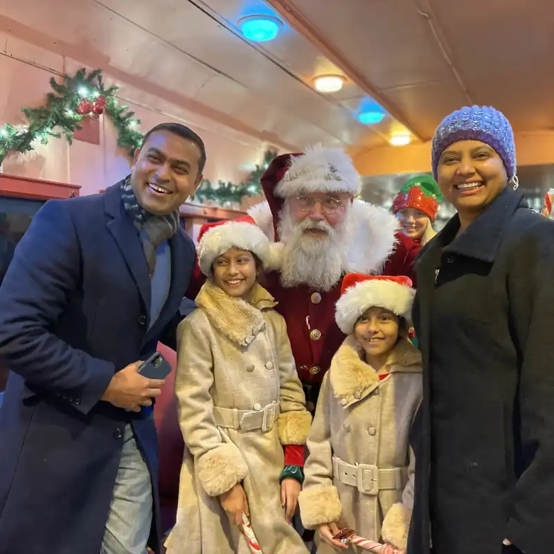 a person standing in front of a group of people posing for the camera