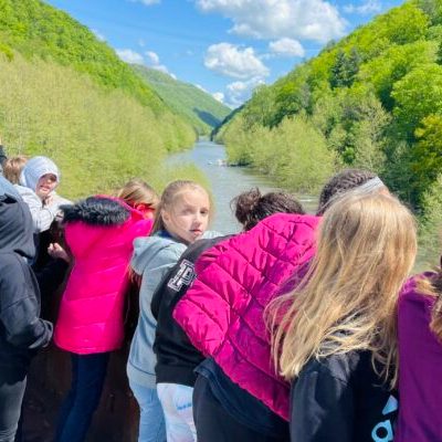 Educationa group on the gondola car crosing the sycamore bridge