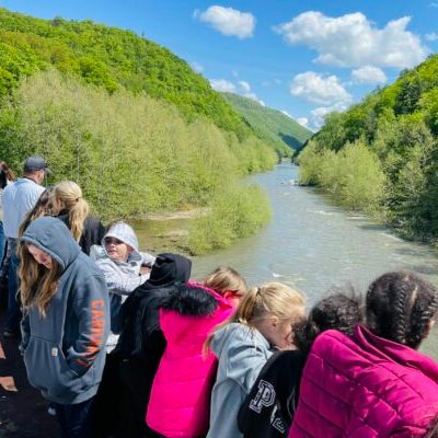 Educationa group on the gondola car crosing the sycamore bridge