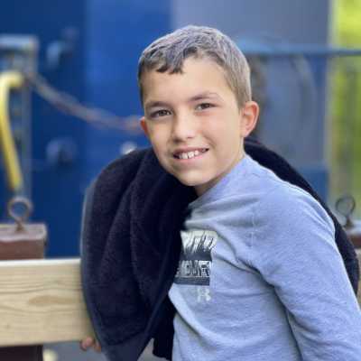 a young boy sitting on the gondola bench