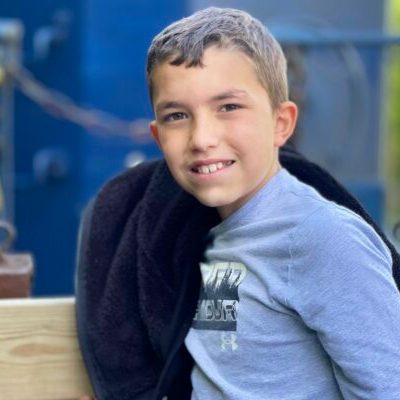 a young boy who is smiling at the camera