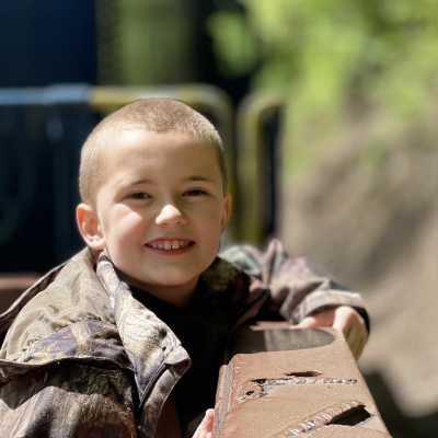 a little boy sitting on the gondola