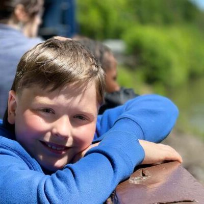 a little boy sitting on a bench